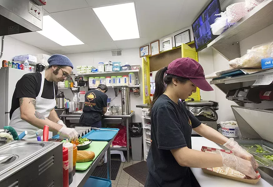 Workers keep things moving in the kitchen. - PHOTO BY MABEL SUEN