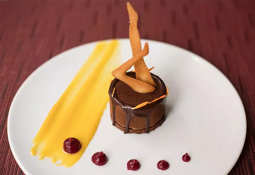 Dark chocolate mousse is served "Radio City Rockette style" in homage to the building’s previous tenants. - MABEL SUEN