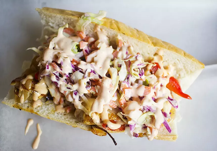 The chicken sandwich is topped with grilled red peppers, cole slaw and housemade hot-sauce aioli on a Vitale's baguette. - PHOTO BY MABEL SUEN
