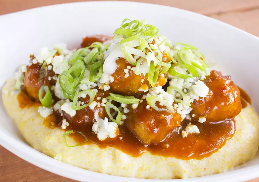 "Buffalo Balls" are tossed in sweet-heat glaze over stone grits with blue cheese and green onions. - PHOTO BY MABEL SUEN