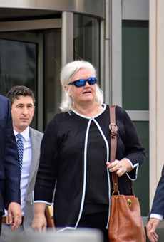 Sheila Sweeney leaves federal court with her attorneys after pleading guilty in a public corruption case.