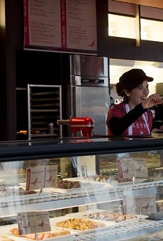 A worker greets customers at Piccione Pastry in 2013.