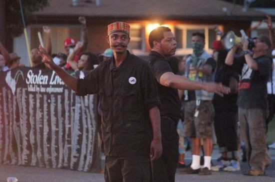 New Black Panther Party members directed traffic and kept the peace Thursday night. - DANNY WICENTOWSKI