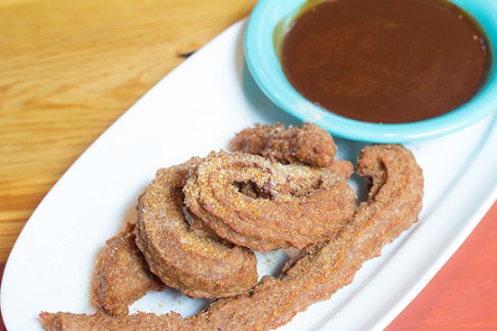 Churros with chocolate sauce for dessert.