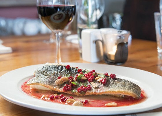 The trout, with Marcona almond, lingonberry, herbs and horseradish flan at Three Flags Tavern. | Corey Woodruff