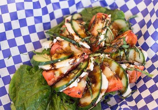 "Mike's Special Tomato Salad" with fresh mozzarella, cucumber, house dressing and balsamic vinegar.
