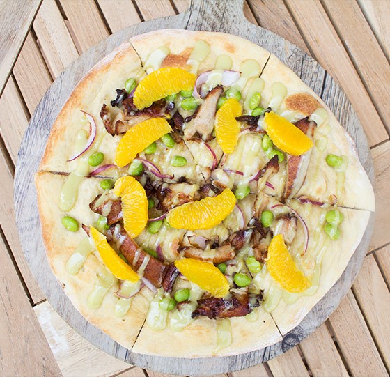 "Asian Chicken" pizza with soy-garlic marinated chicken, sesame oil, red onion, edamame, orange segments and wasabi aioli. | Photos by Mabel Suen