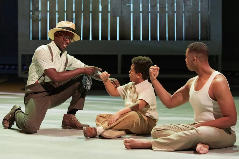 Jeremy Denis (center) and Davóne Tines (right), with Michael Redding, portray columnist Charles Blow at different stages of life. - ERIC WOOLSEY