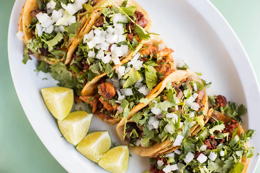 Chorizo, lengua, pollo, cabeza and asada tacos wrapped in corn tortillas are just the first reason to visit Malintzi Mexican Grocery. - MABEL SUEN