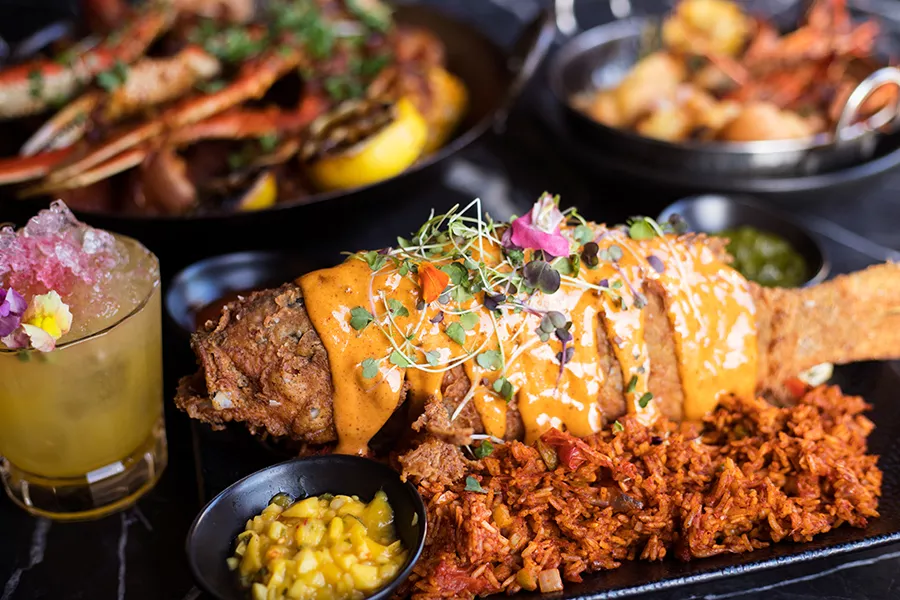 The Caribbean red snapper is breaded, fried and served whole alongside rice and pickled Napa cabbage slaw. - MABEL SUEN