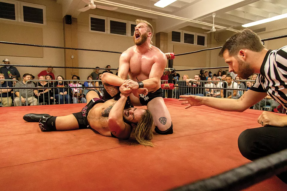 Josh Briggs (left) grapples on the ground with Tyler Colton. - MONICA MILEUR