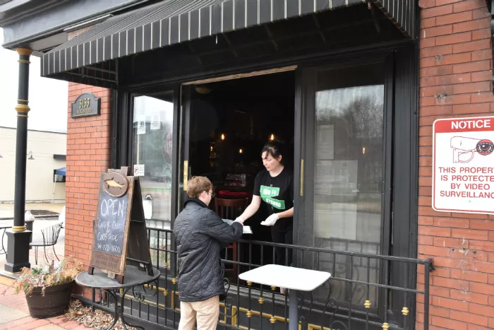 Three Monkeys co-owner Mary Rice helps a customer. - DOYLE MURPHY
