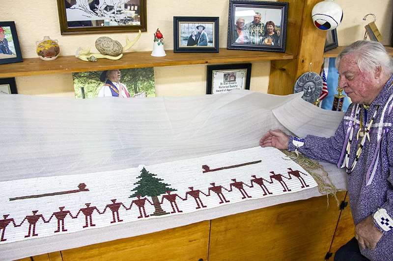 Descombes poses next to what he describes as "the largest known wampum belt." He says his proof of Cherokee heritage includes "thousands of pounds" of secret genealogy records. - DANNY WICENTOWSKI