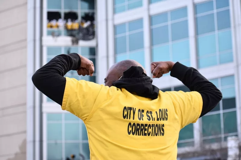 A man picked up a shirt thrown by inmates and put it on in support. - DOYLE MURPHY