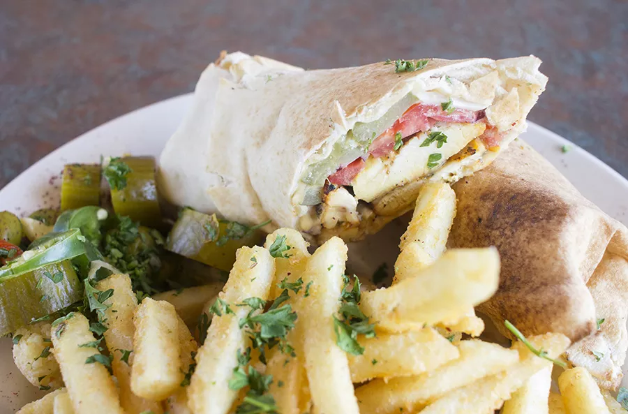Chicken shawarma with grilled chicken, onions, pickles, tomatoes and tahini on toasted pita bread. - PHOTO BY MABEL SUEN