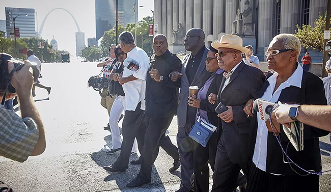 Anthony Shahid - (in all black) and Phillip Duvall prodded the circuit attorney to give the Stockley case a fresh look in 2016. - THEO WELLING