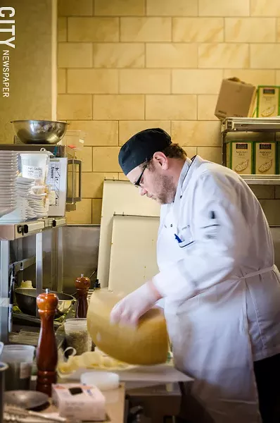 Chef Steven Terry grating fresh cheese. - PHOTO BY MARK CHAMBERLIN