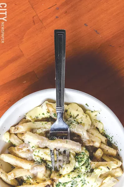 Duck fat frites, duck gravy, and First Light Creamery cheese curds makes up Lento’s poutine. - PHOTO BY MARK CHAMBERLIN