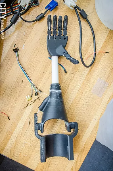 Plastic fingers on the hand are controlled by flexing the wrist, which pulls on strings that act as tendons. - PHOTO BY MARK CHAMBERLIN