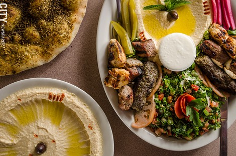 Sultan Lebanese Cuisine & Bakery specializes in traditional Lebanese dishes like (top left) Za'atar Manakeesh (flatbread with thyme, sumac, and olive oil) and Mashawi Combo (tabouli, hummus, chicken, beef, kafta kebab skewers, and pickled vegetables) - PHOTO BY MARK CHAMBERLIN