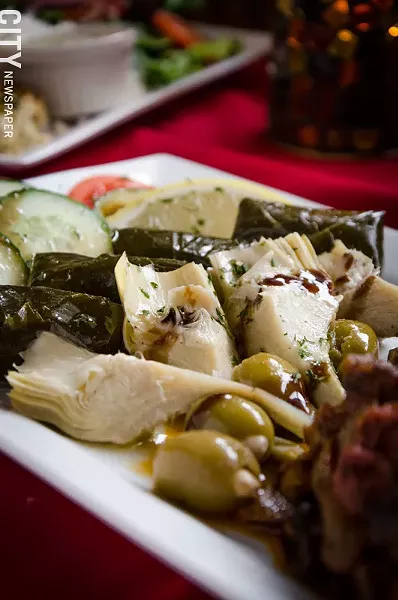The Mediterranean antipasta appetizer with dolmades, artichoke hearts, olives, feta, and roasted red peppers. - PHOTO BY MARK CHAMBERLIN