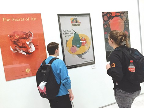 Students check out the Milton Glaser poster show currently on view at RIT's University Gallery. - PHOTO COURTESY SUE WEISLER/RIT UNIVERSITY NEWS SERVICES