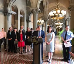 At an early June press conference on climate legislation: Senate sponsor Todd Kaminsky at the podium; to the right, Julie Tighe with the New York League of Conservation Voters - WXXI NEWS