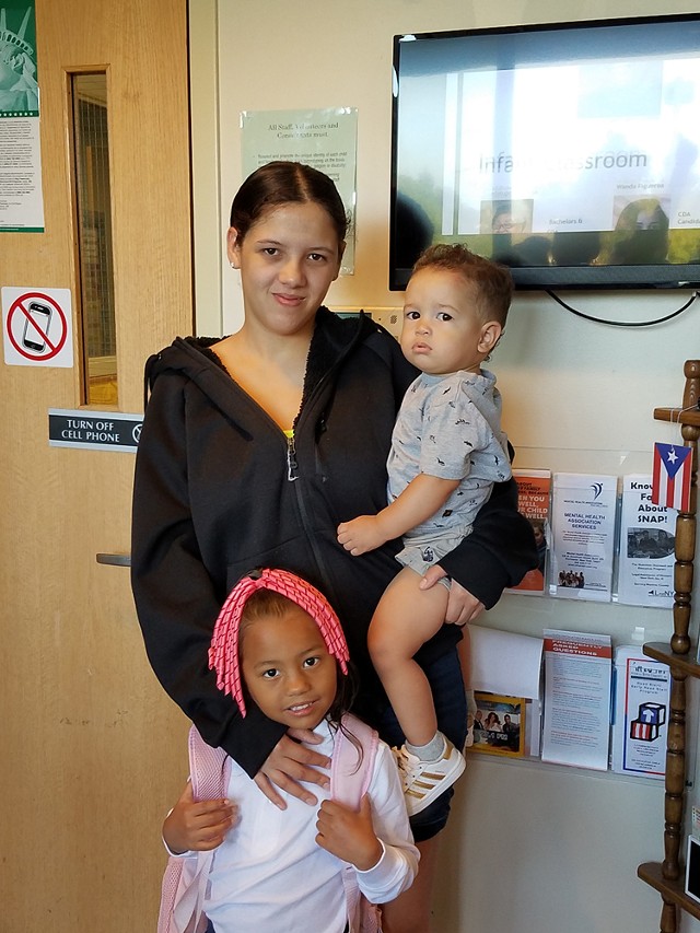 Karla Reyes Ríos, photographed with two of her children, has struggled, but, she says, “I like Rochester a lot.” - PHOTO BY LILLIAN COLÓN, IBERO
