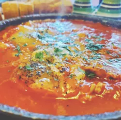 A North African and Middle Eastern classic of eggs poached in tomato sauce, Shakshuka comes in infinite combinations of spices and different cheeses. - PHOTO BY J. NEVADOMSKI