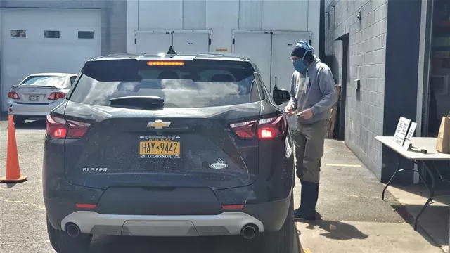 Swiftwater owner Andy Cook delivers beer to a curbside customer on April 22, 2020. - PHOTO BY GINO FANELLI