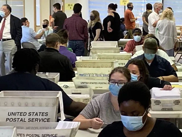 Monroe County Board of Elections workers count absentee ballots at the board's service center. - PHOTO BY JAMES BROWN, WXXI NEWS