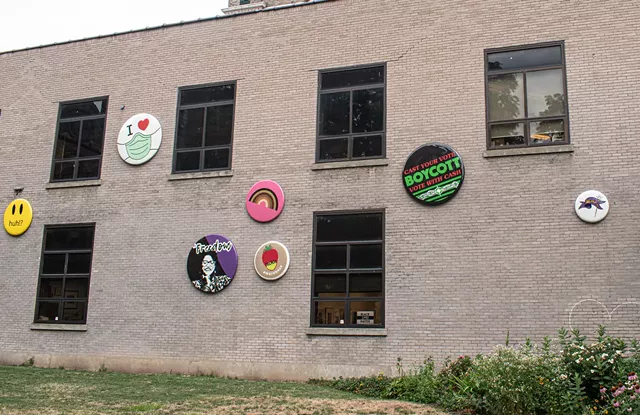 A cluster of the "button" designs for the recent public art installation, "Underpin & Overcoat" on the side of Rochester Contemporary Art Center in the East End. - PHOTO BY JACOB WALSH