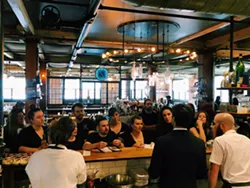 Chuck Cerankosky talks with the staff of Good Luck about coronavirus protocols for the restaurant last March. - PHOTO BY MIKE MARTINEZ