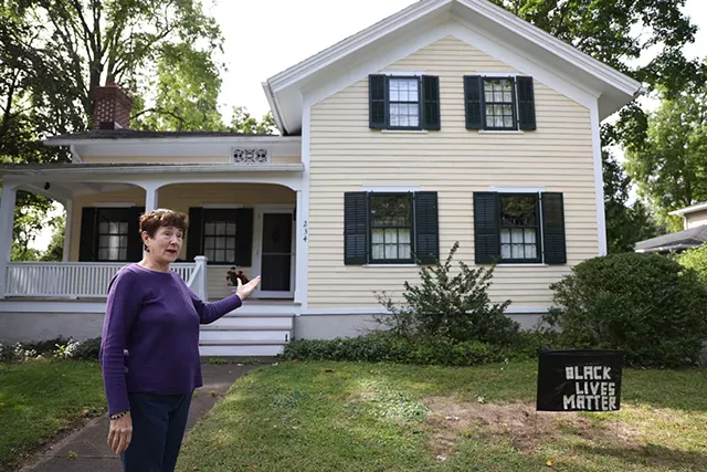Lynn Barber is proud of the history of her home on South Main Street in Fairport, but called the language of the historical sign denoting it "racist and offensive." - PHOTO BY MAX SCHULTE