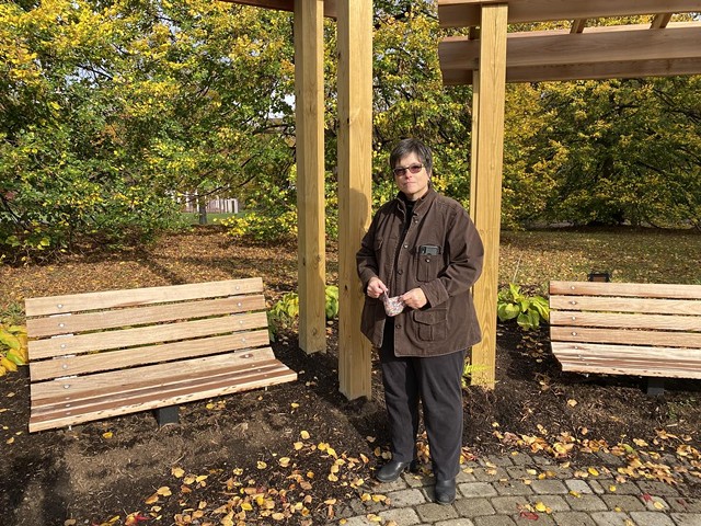 Gillian Conde stands in the Remember Garden she helped create. - PHOOT BY VERONICA VOLK