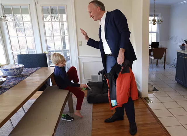 Douglas Maguire and his 6-year-old son, Charlie, in their Pittsford home. - PHOTO BY MAX SCHULTE