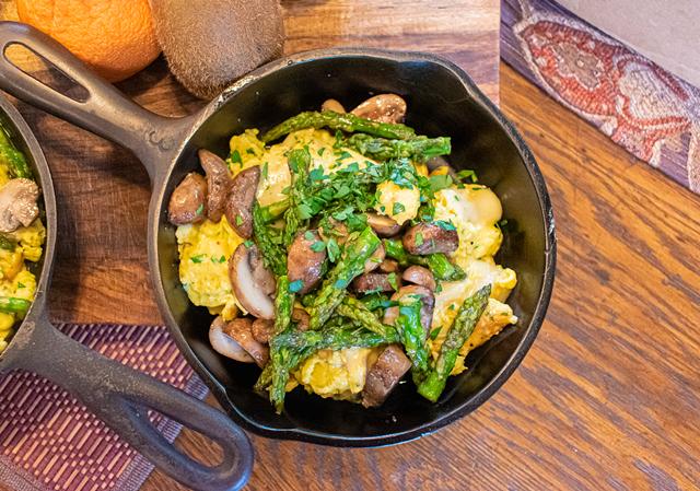 Asparagus and mushrooms give this scramble an earthy, hearty flavor, and the Swiss raclette cheese gives the dish a creamy, slightly sweet flavor. - PHOTO BY JACOB WALSH