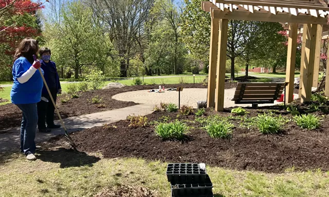 Gillian Conde, right, talks with a volunteer as the garden clean-up comes to a close at the Remember Garden on Thursday. - PHOTO BY NOELLE E. C. EVANS