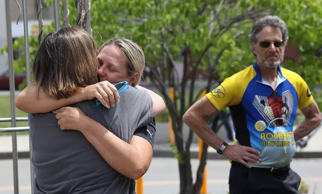 Nikki Acquisto hugs Bobby Koval, who talked about how her son, Jack, was struck and killed by an off-duty New York City police officer. - PHOTO BY MAX SCHULTE
