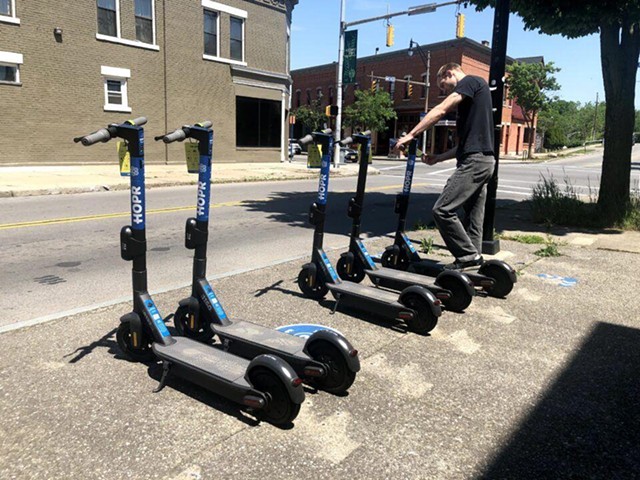 A worker lines up some of the electric scooters that HOPR uses in its bike and scooter share program. - PHOTO PROVIDED BY HOPR