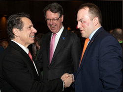 Irondequoit Supervisor Dave Seeley, right, greets Gov. Andrew Cuomo as Brighton Supervisor Bill Moehle looks on in 2019. - PHOTO PROVIDED BY THE OFFICE OF GOV. ANDREW CUOMO
