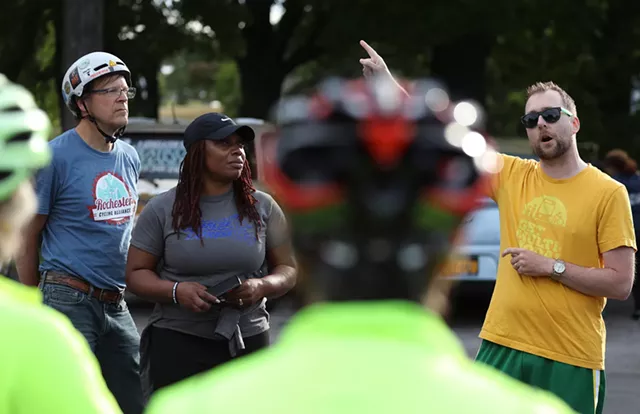 Jesse Peers with Reconnect Rochester outlines the route for bike riders before leaving Maplewood Park to ride along the Genesee River. - PHOTO BY MAX SCHULTE