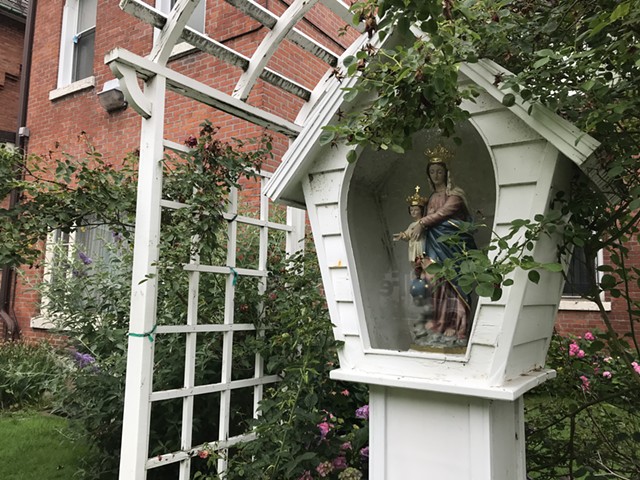 A Madonna and Child statue in the yard at Our Lady of Victory Church on Pleasant Street. - PHOTO BY DAVID ANDREATTA