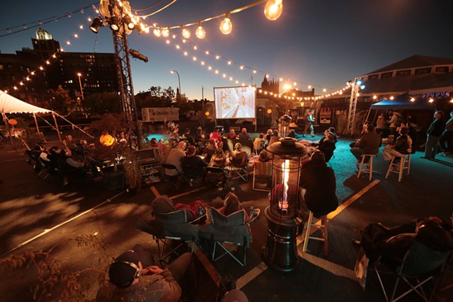 Rochester Fringe festivalgoers watch a movie outdoors at One Fringe Place. - PHOTO PROVIDED