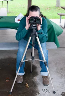 Betsy Ukeritis, interregional environmental educator for the DEC, demonstrates using a tripod to hold a pair of binoculars.