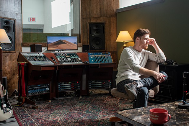 Josh PEttinger, sitting in Studio A at Wicked Squid Studios, prefers sounds that are "punchy" and "controlled but also emotive." - PHOTO BY JACOB WALSH