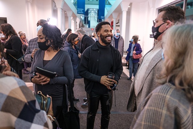Joshua Rashaad McFadden mingles with George Eastman Museum attendees at the opening reception for the photography retrospective "Joshua Rashaad McFadden: I Believe I'll Run On." - PHOTO BY ERICH CAMPING