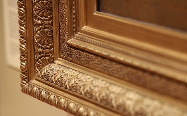 A corner of the new hand-carved frame around Jean-Leon Gerome's "Interior of a Mosque." - PHOTO BY MAX SCHULTE