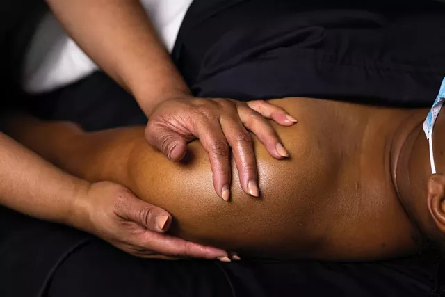 Raquel Walker massages a client in her space inside Plushh Salon & Spa in Greece. - PHOTO BY LAUREN PETRACCA