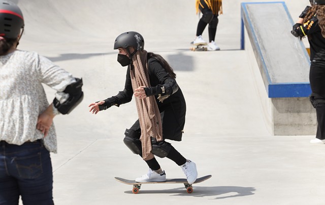 Rochester International Academy student Sadia works on rolling down a bank at the Roc City Skatepark. - PHOTO BY MAX SCHULTE